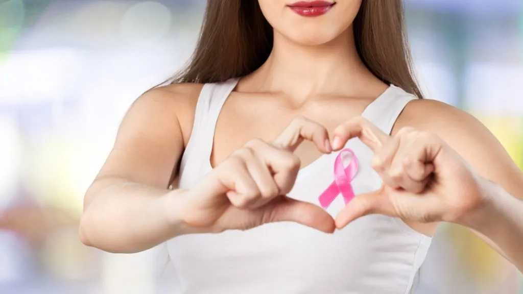 Close up of woman with pink ribbon in her hands