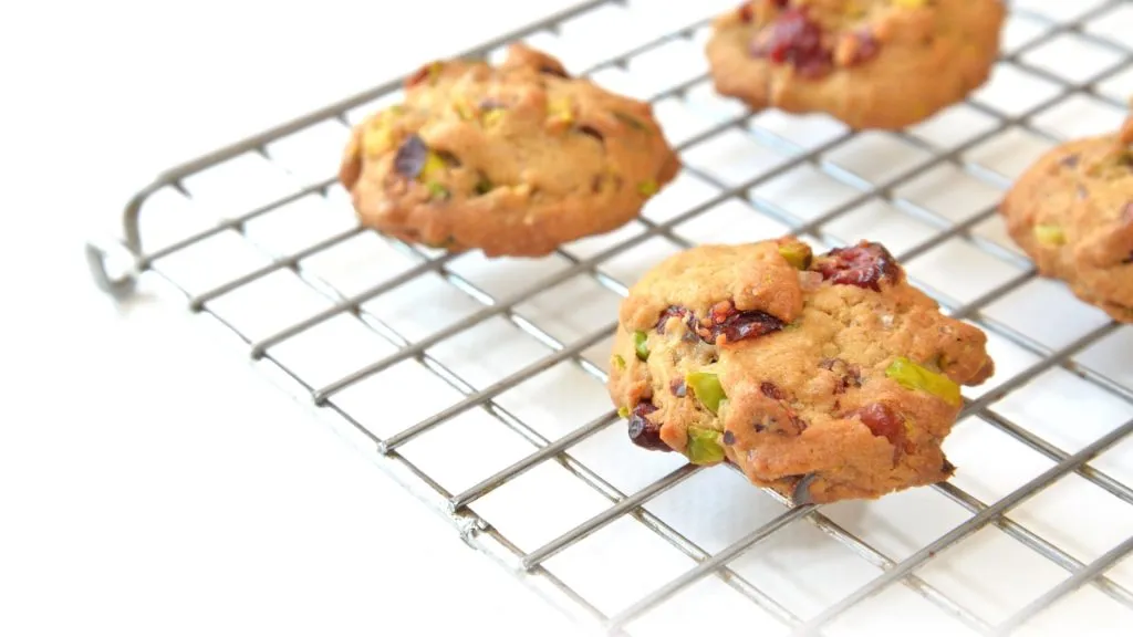 Homemade pistachio and cranberry cookies on cooling rack