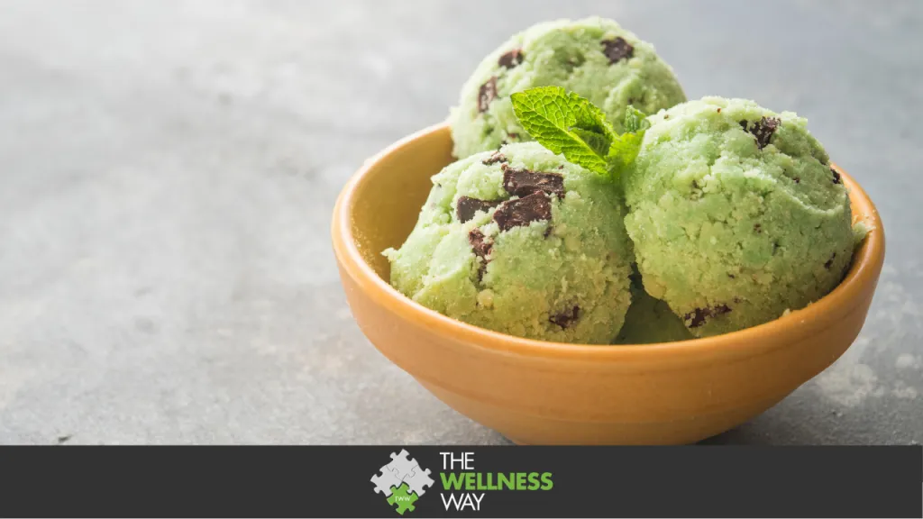 wooden bowl with three scoops of mint chocolate chip ice cream inside
