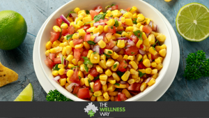 Mexican Corn Salsa in white bowl with lime and tortilla chips