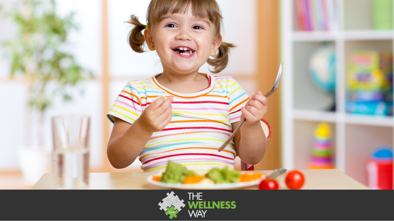 Happy kid girl eating vegetables. healthy nutrition for children