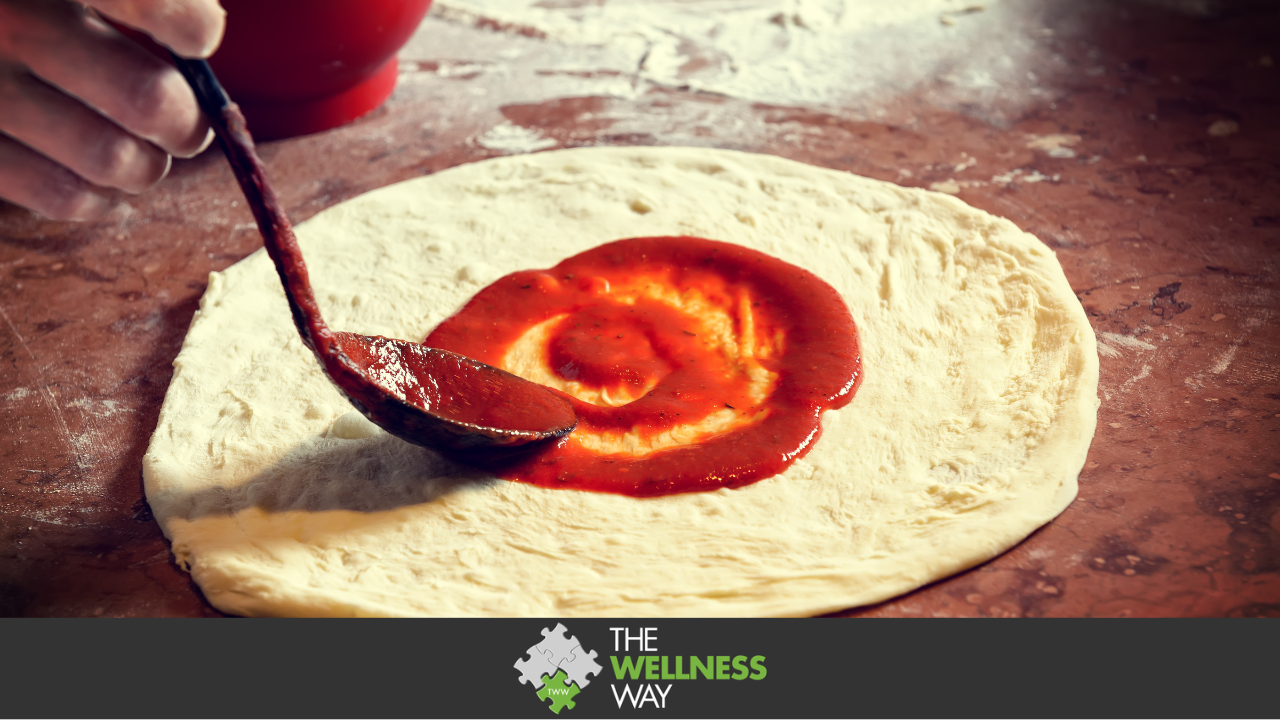 Fresh original italian raw pizza, dough preparation in traditional style. applying a tomato sauce