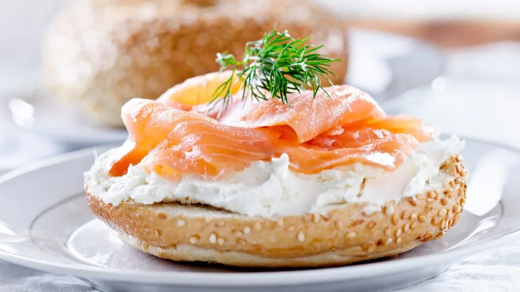 smoked salmon, goat cheese, and dill on a bagel