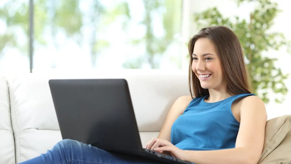 Young woman on laptop smiling