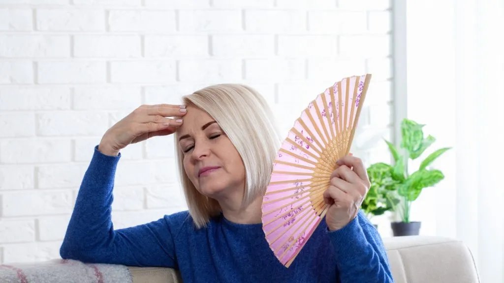 Menopausal woman with pink Chinese fan