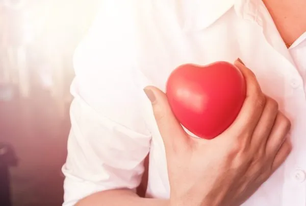 Woman holding a red heart cardiovascular health