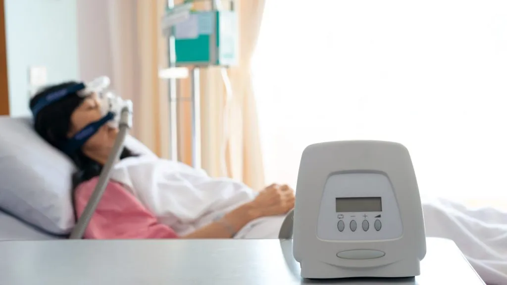 Cpap machine is treating senior patient woman wearing Cpap mask sleeping