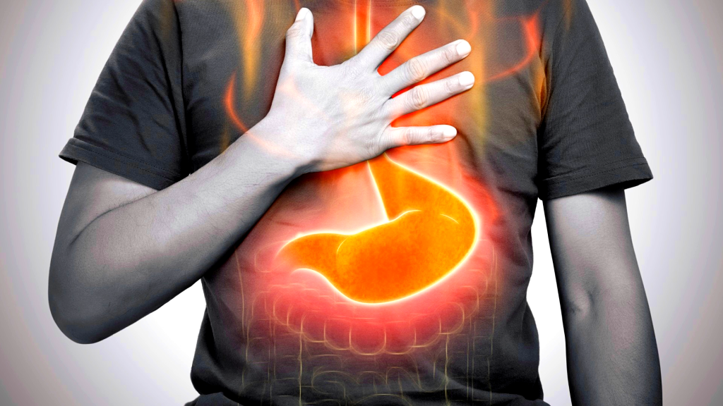 A man burning sensation in chest from acid reflux on gray background.