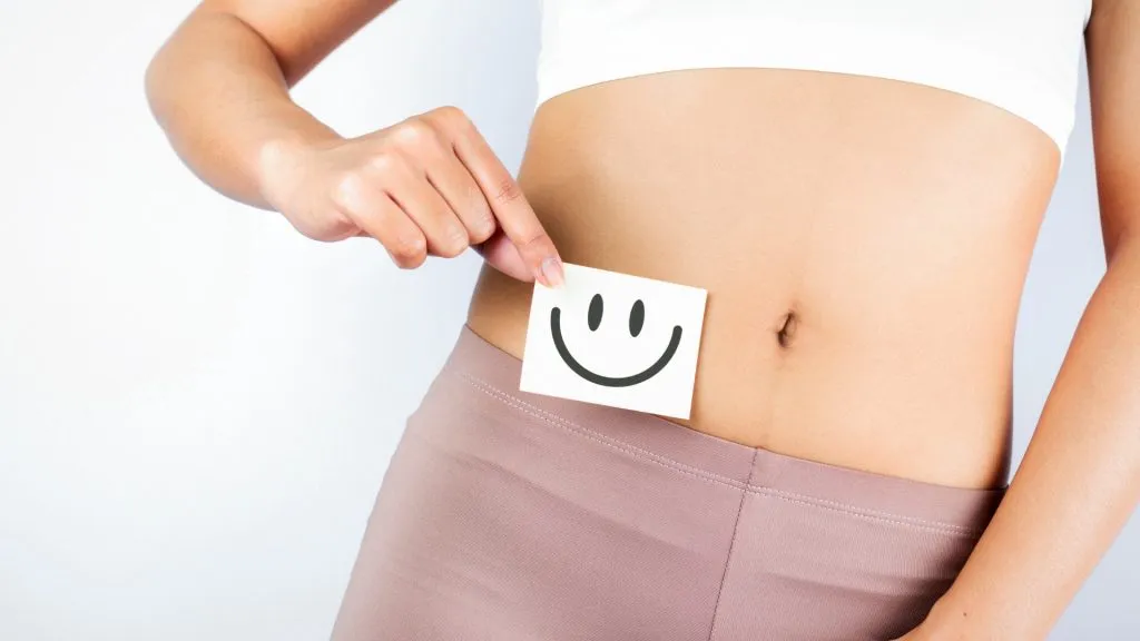 Healthy Female With Beautiful Fit Slim Body Holding White Card With Happy Smiley Face.