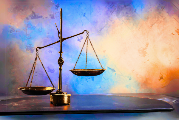 Scales on a table with colorful background. Imbalanced scales